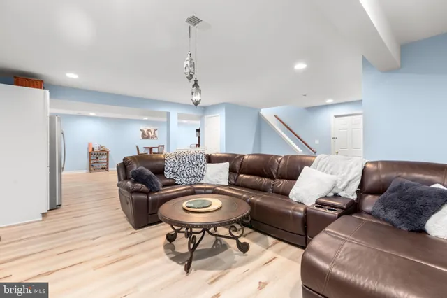 a kitchen with stainless steel appliances a stove a sink a microwave a refrigerator and cabinets