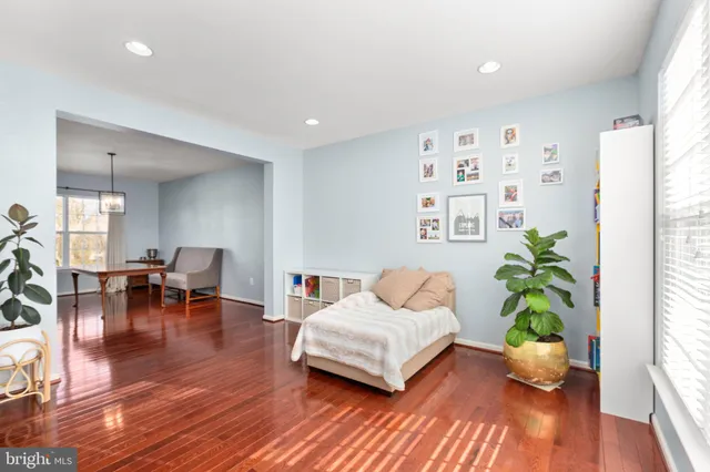 a view of a hallway with wooden floor and stairs
