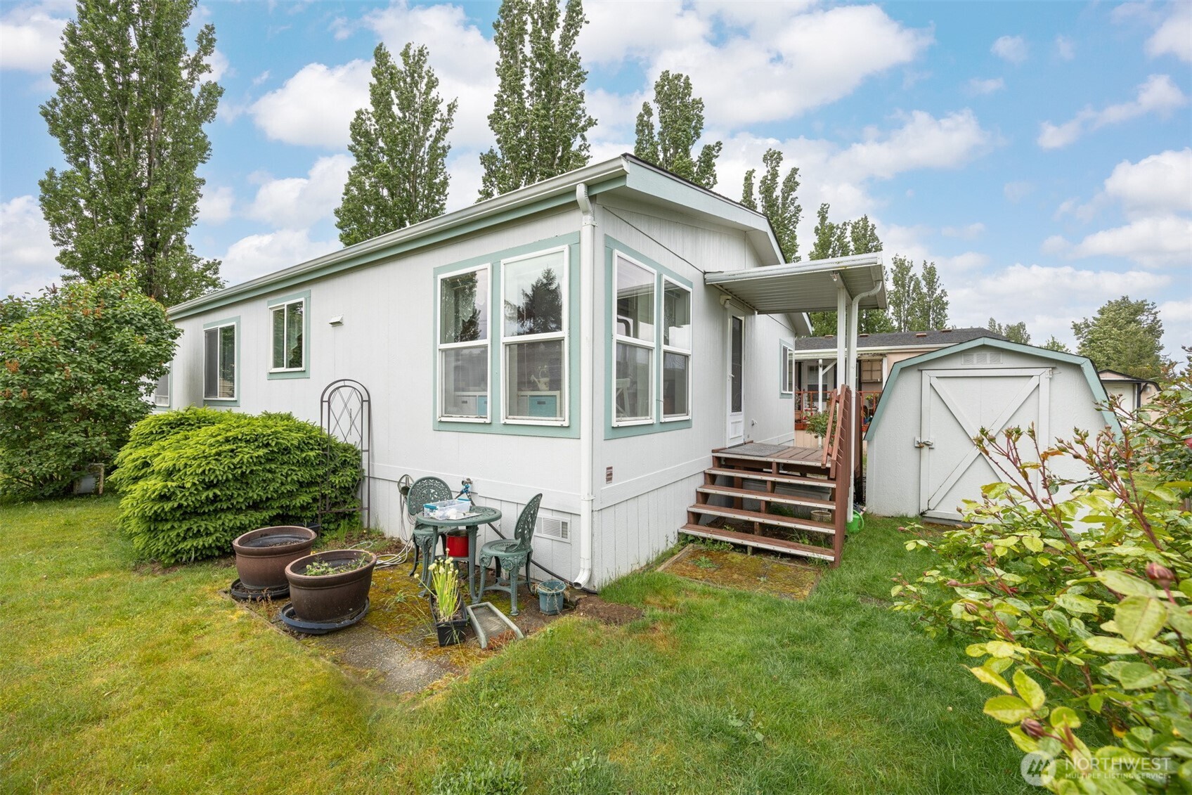 380 East Pole Road, Unit 6 Lynden, WA 98264 - Photo 34 of 40 a view of a house with a yard and sitting area