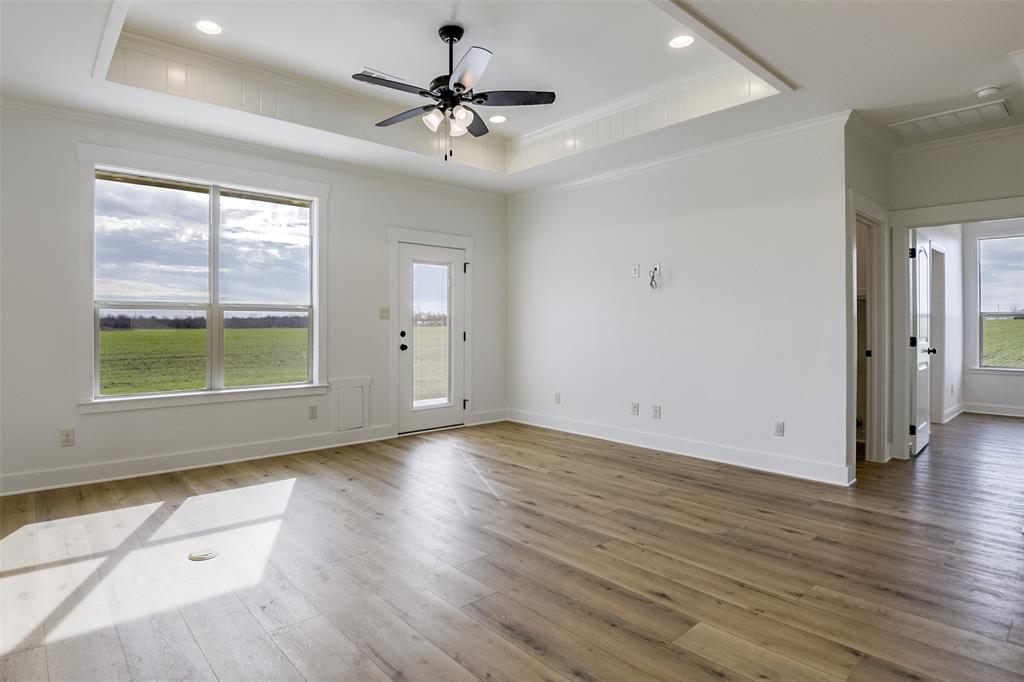 138 Zmolek Road Alma, TX 75119 - Photo 11 of 29 an empty room with wooden floor and windows