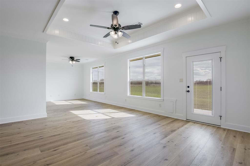 138 Zmolek Road Alma, TX 75119 - Photo 12 of 29 a view of an empty room with wooden floor and a window
