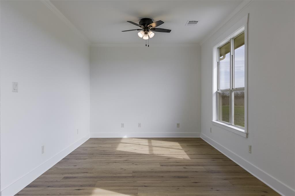 138 Zmolek Road Alma, TX 75119 - Photo 13 of 29 wooden floor in an empty room with a window