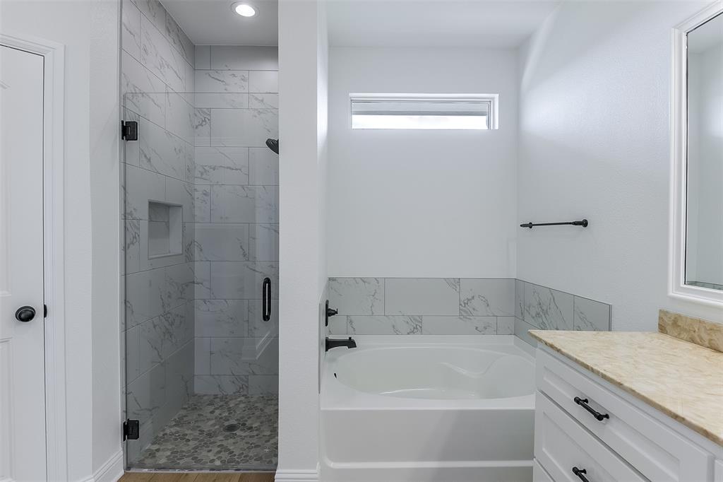 138 Zmolek Road Alma, TX 75119 - Photo 19 of 29 a bathroom with a bathtub and a shower