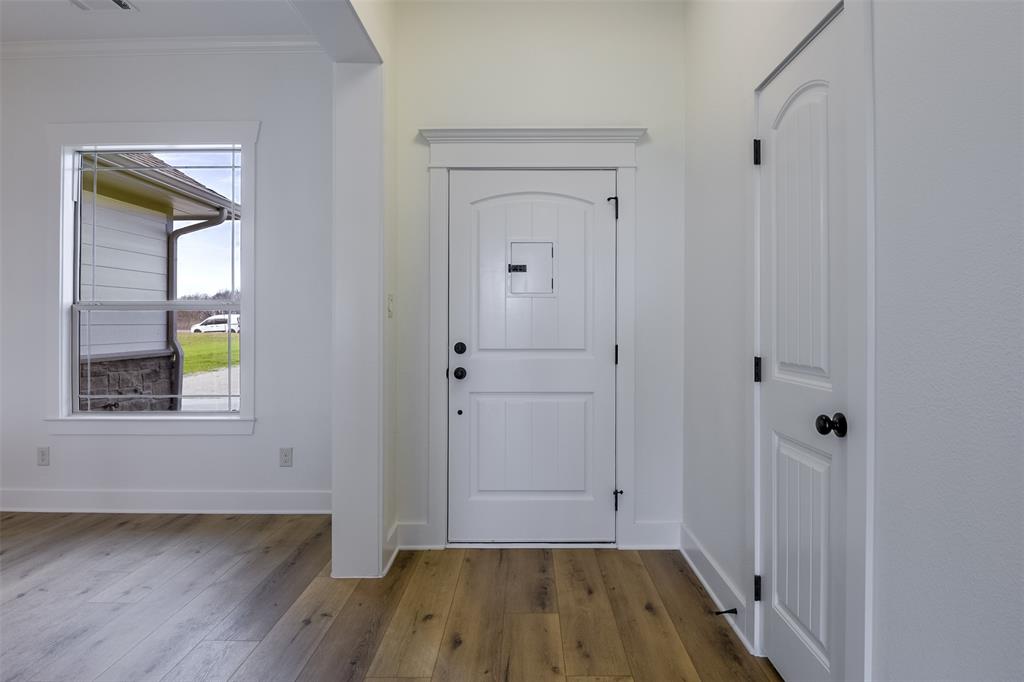 138 Zmolek Road Alma, TX 75119 - Photo 2 of 29 a view of a hallway with wooden floor and closet