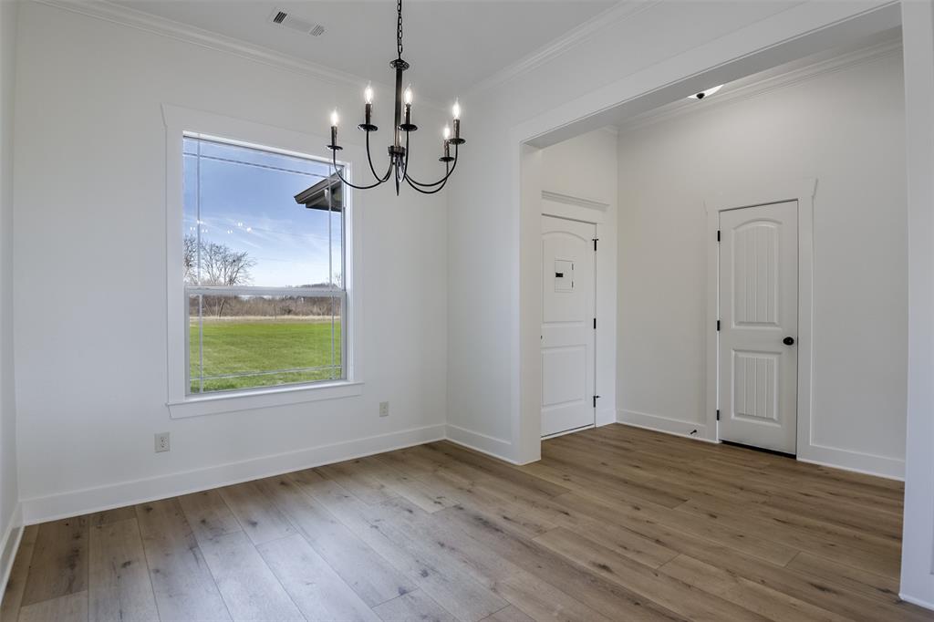 138 Zmolek Road Alma, TX 75119 - Photo 3 of 29 a view of an empty room with wooden floor and a window
