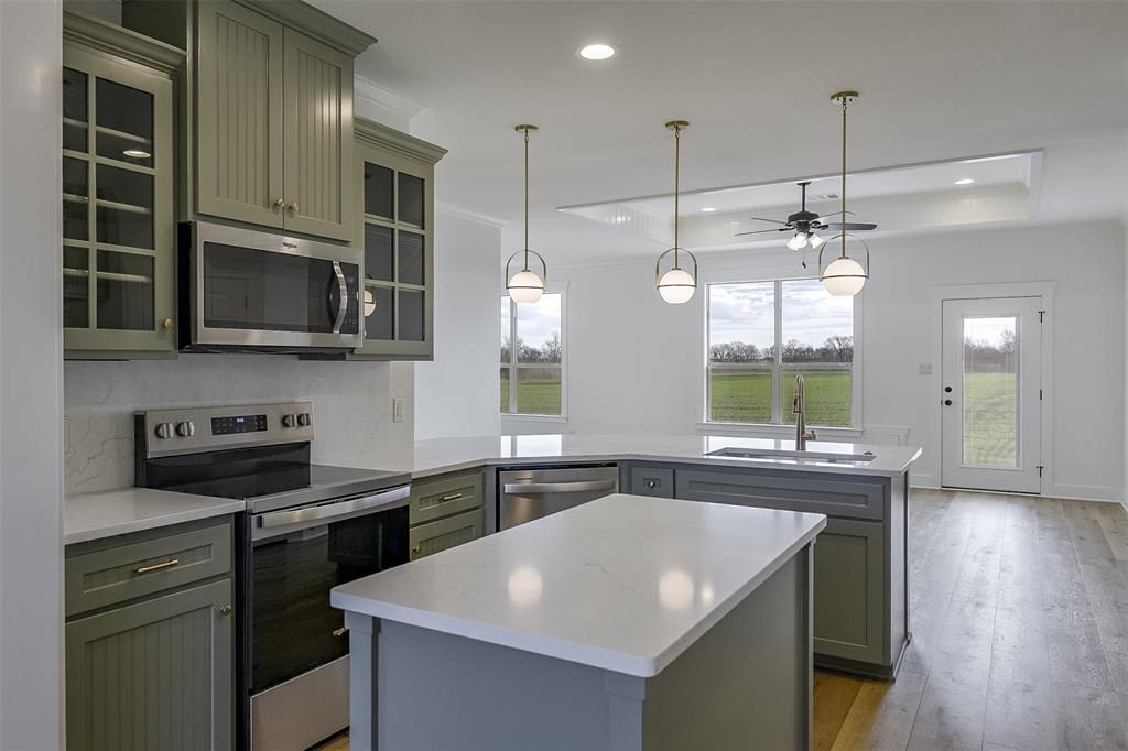138 Zmolek Road Alma, TX 75119 - Photo 5 of 29 a kitchen that has a sink a stove and microwave