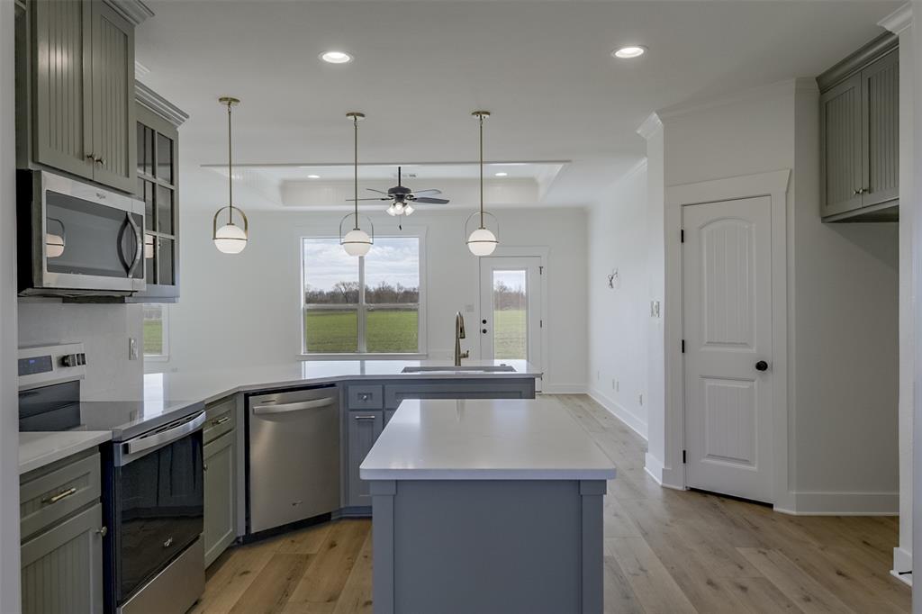 138 Zmolek Road Alma, TX 75119 - Photo 6 of 29 a kitchen with stainless steel appliances granite countertop a sink a stove and a refrigerator