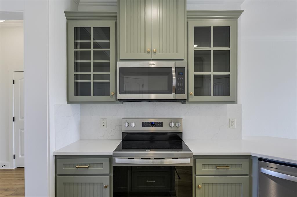 138 Zmolek Road Alma, TX 75119 - Photo 7 of 29 a kitchen with granite countertop a stove and a microwave