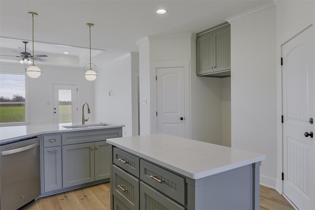 138 Zmolek Road Alma, TX 75119 - Photo 8 of 29 a kitchen with a sink dishwasher and a refrigerator with wooden floor
