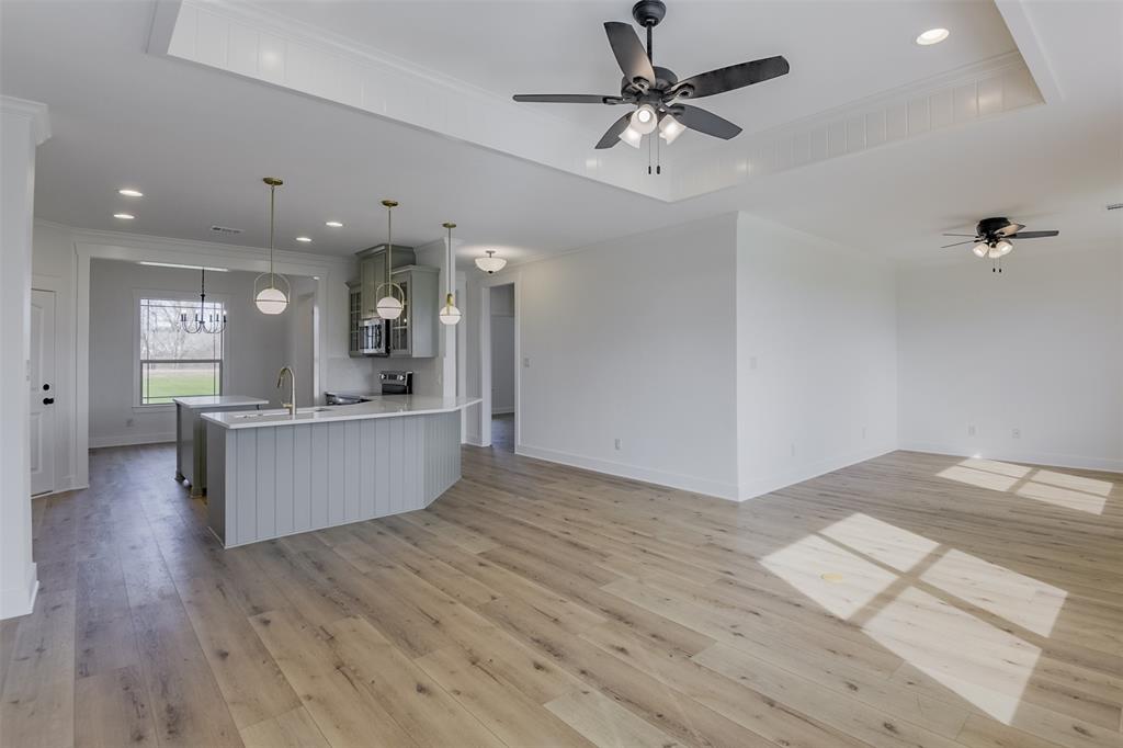 138 Zmolek Road Alma, TX 75119 - Photo 10 of 29 a large kitchen with stainless steel appliances kitchen island a large island in the center