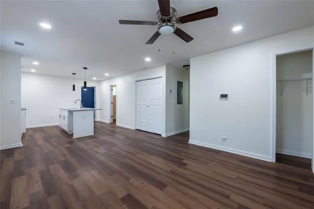 a view of a kitchen with a sink and a refrigerator