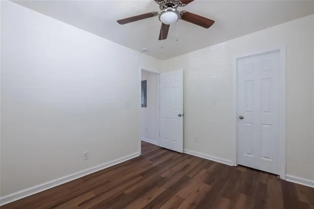 a view of an empty room with wooden floor