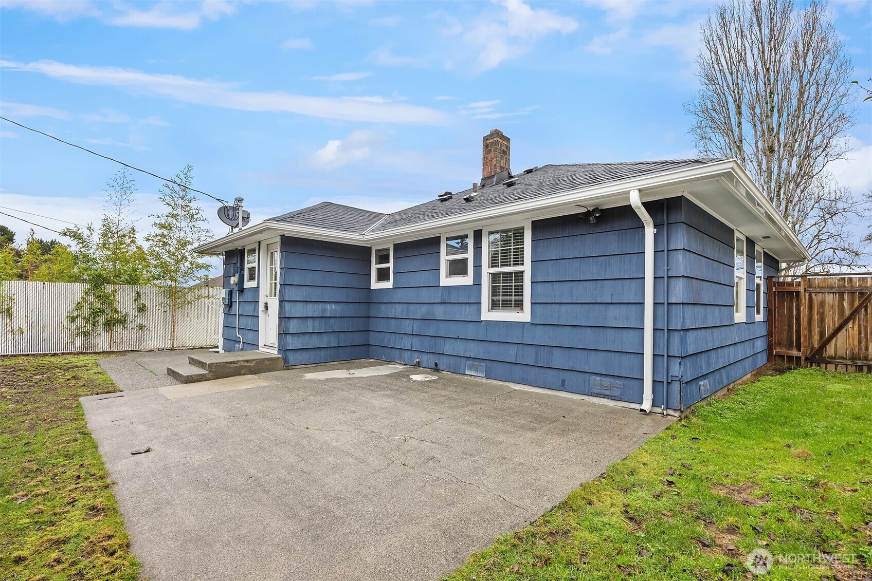 6741 34th Avenue Southwest Seattle, WA 98126 - Photo 15 of 25 a front view of a house with a yard