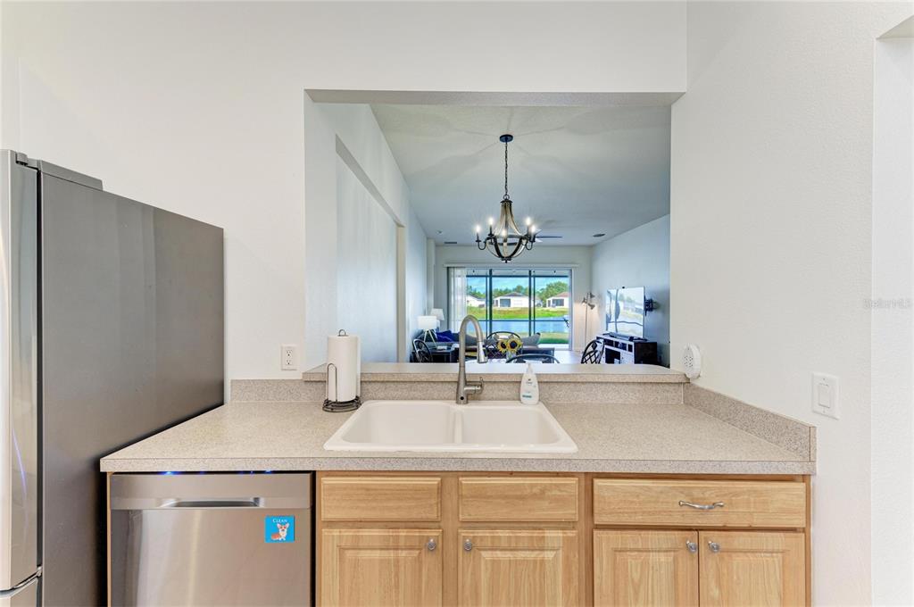 9950 52nd Street East Parrish, FL 34219 - Photo 13 of 48 a kitchen with a sink and a refrigerator