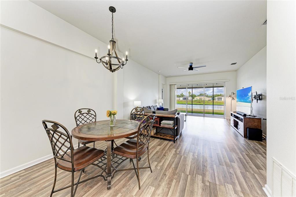 9950 52nd Street East Parrish, FL 34219 - Photo 14 of 48 a dining room with furniture a chandelier and wooden floor