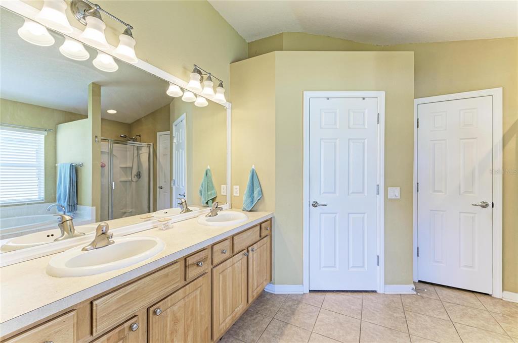 9950 52nd Street East Parrish, FL 34219 - Photo 27 of 48 a bathroom with a double vanity sink and a mirror