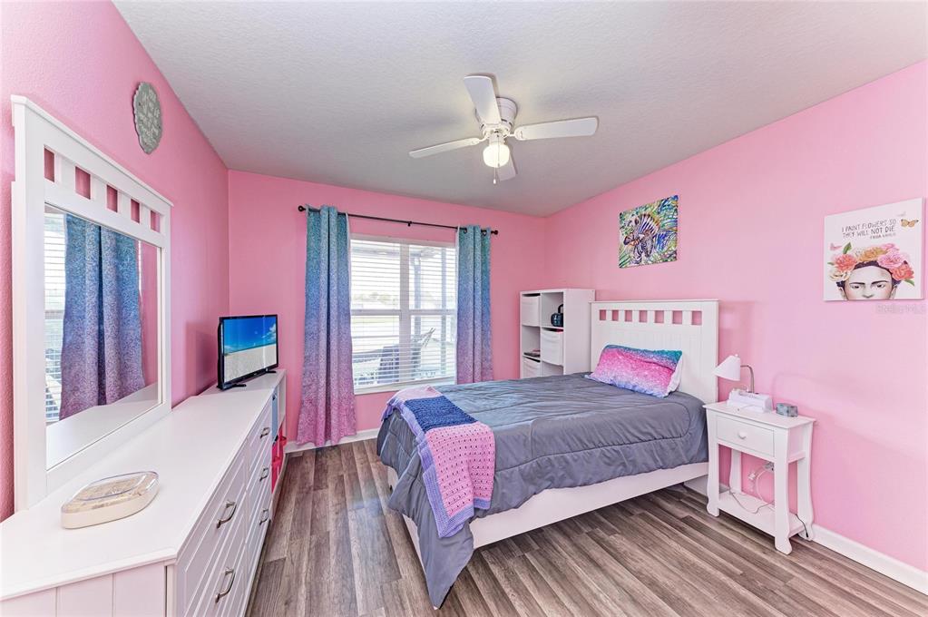 9950 52nd Street East Parrish, FL 34219 - Photo 31 of 48 a bedroom with a bed and wooden floor