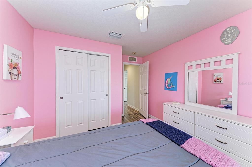 9950 52nd Street East Parrish, FL 34219 - Photo 32 of 48 a bedroom with a bed and a dresser