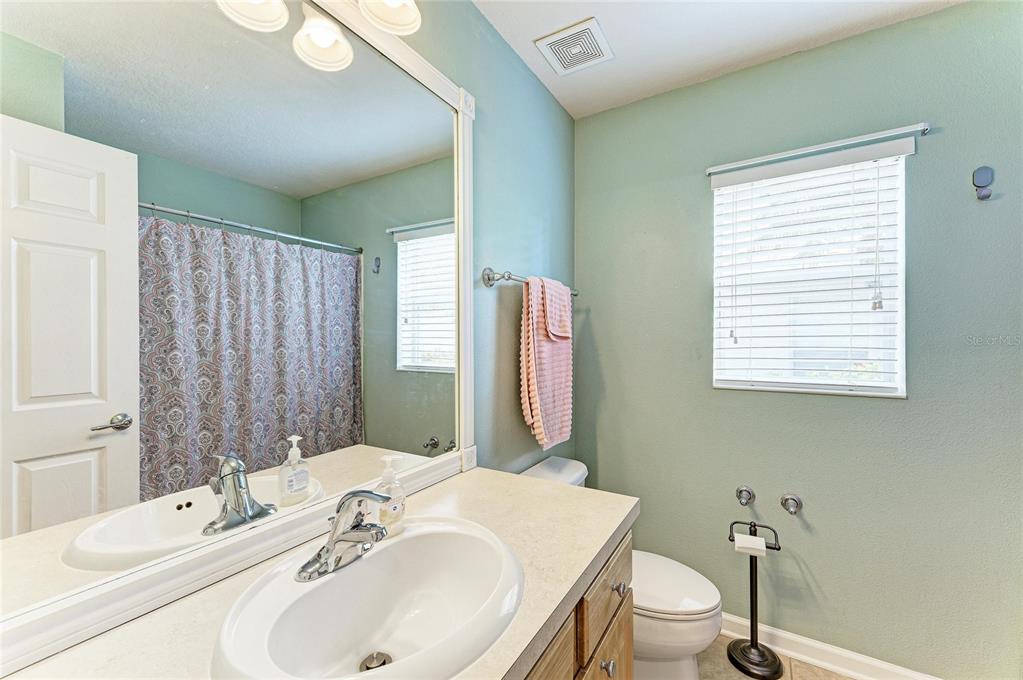 9950 52nd Street East Parrish, FL 34219 - Photo 33 of 48 a bathroom with a sink and a mirror