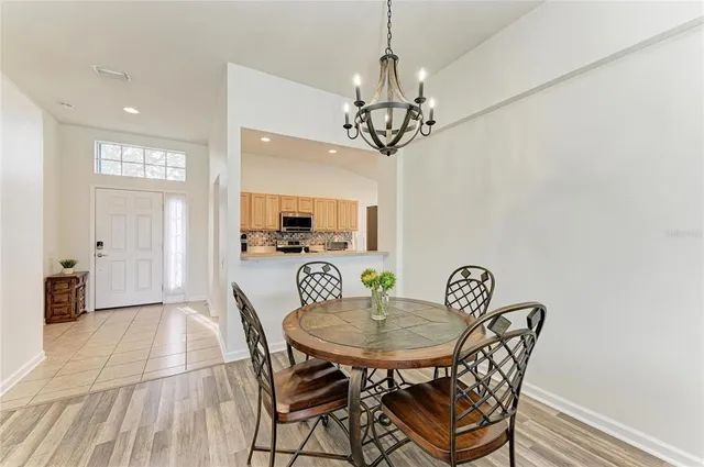 a view of a dining room with furniture wooden floor and chandelier