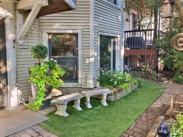 a view of a house with a yard and sitting area