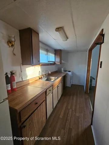 a kitchen with a sink appliances and cabinets