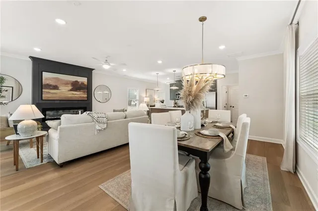 a living room with furniture a dining table and a flat screen tv