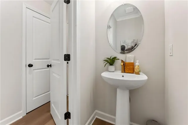a bathroom with a sink a mirror and toilet