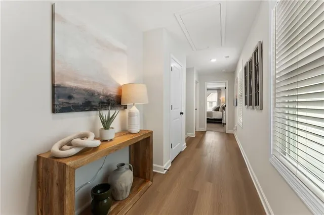 a view of a hallway to a livingroom with furniture