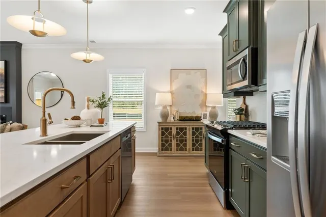 a kitchen with stainless steel appliances granite countertop a sink stove and refrigerator