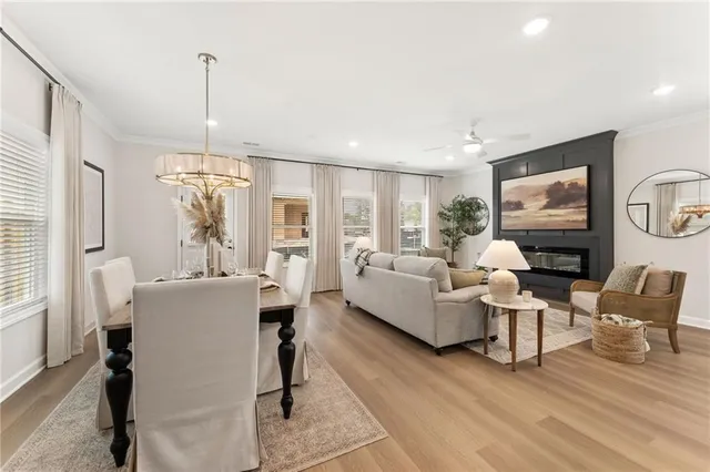 a living room with fireplace furniture and a wooden floor