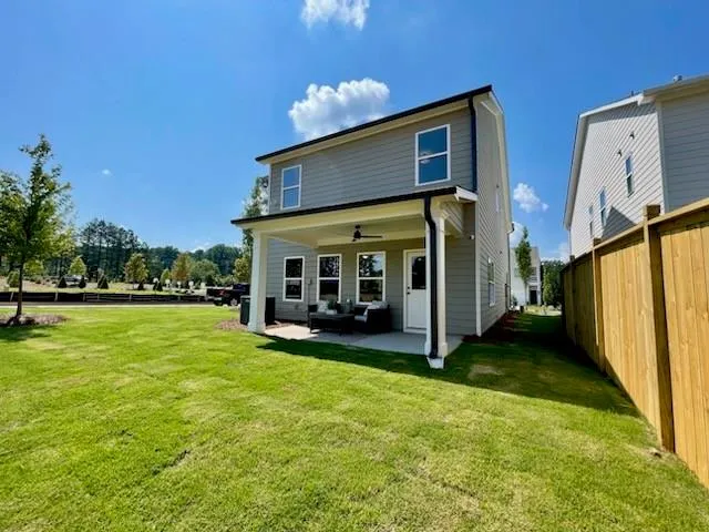a view of a house with backyard porch and sitting area