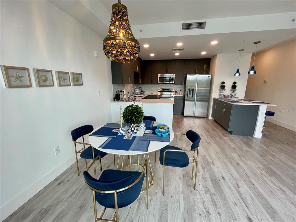 1709 North Tamiami Trail, Unit 213 Sarasota, FL 34234 - Photo 12 of 49 a outdoor dining room with furniture and chandelier