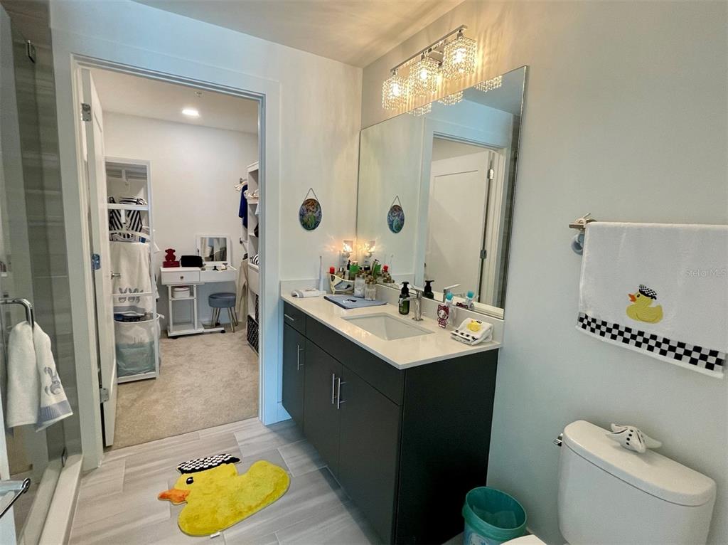 1709 North Tamiami Trail, Unit 213 Sarasota, FL 34234 - Photo 18 of 49 a bathroom with a sink a toilet and a mirror