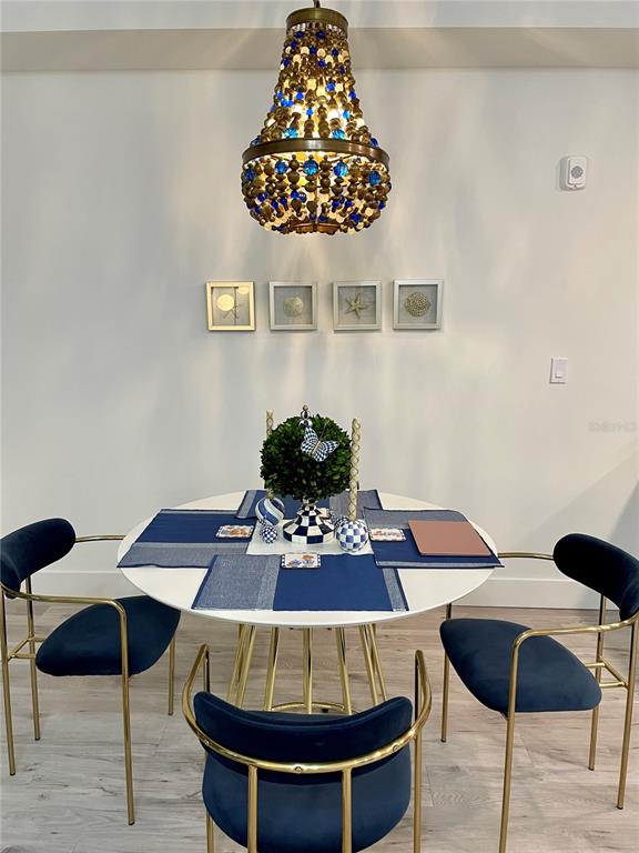 1709 North Tamiami Trail, Unit 213 Sarasota, FL 34234 - Photo 19 of 49 a table with a vase and a chandelier