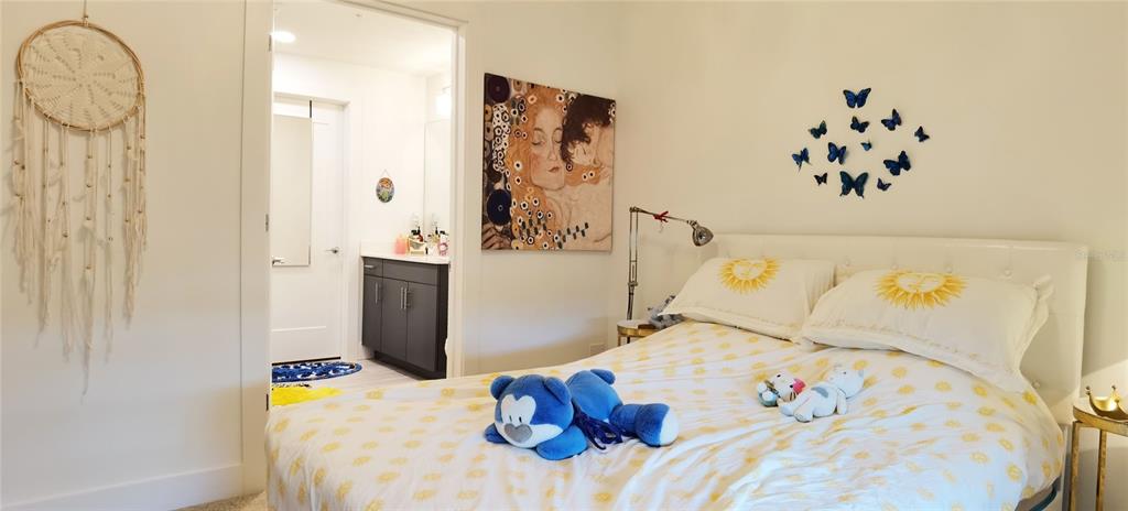 1709 North Tamiami Trail, Unit 213 Sarasota, FL 34234 - Photo 23 of 49 a bedroom with a bed and a chandelier