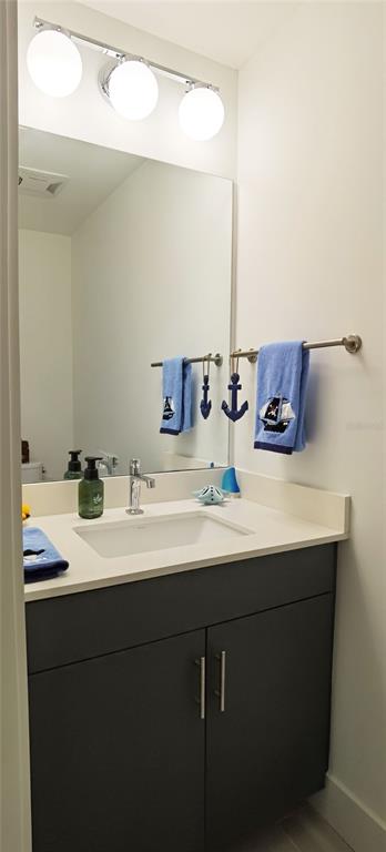 1709 North Tamiami Trail, Unit 213 Sarasota, FL 34234 - Photo 25 of 49 a bathroom with a sink and a mirror