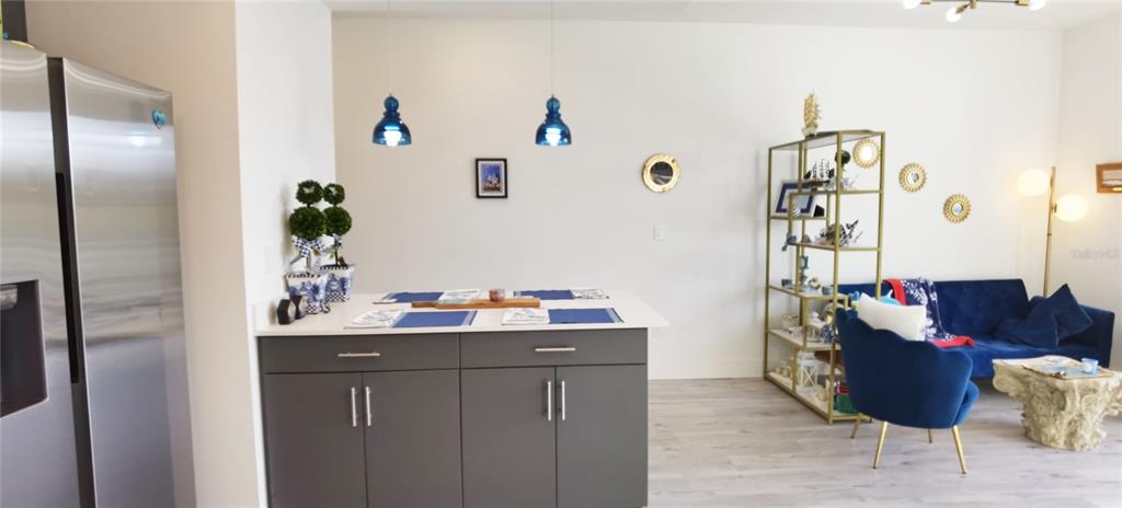 1709 North Tamiami Trail, Unit 213 Sarasota, FL 34234 - Photo 28 of 49 a living room with furniture and wooden floor