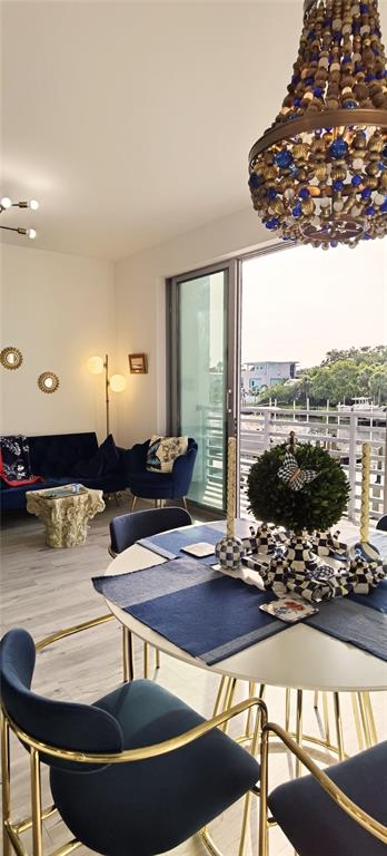 1709 North Tamiami Trail, Unit 213 Sarasota, FL 34234 - Photo 34 of 49 a living room with dining table and a floor to ceiling window