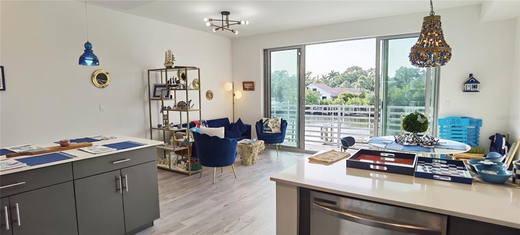 1709 North Tamiami Trail, Unit 213 Sarasota, FL 34234 - Photo 36 of 49 a room with furniture a chandelier and a window