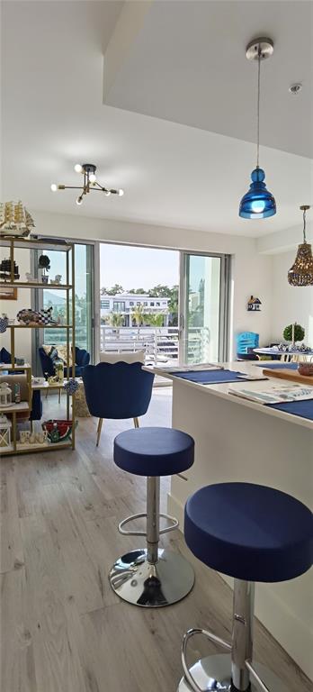 1709 North Tamiami Trail, Unit 213 Sarasota, FL 34234 - Photo 38 of 49 a room with furniture and a chandelier