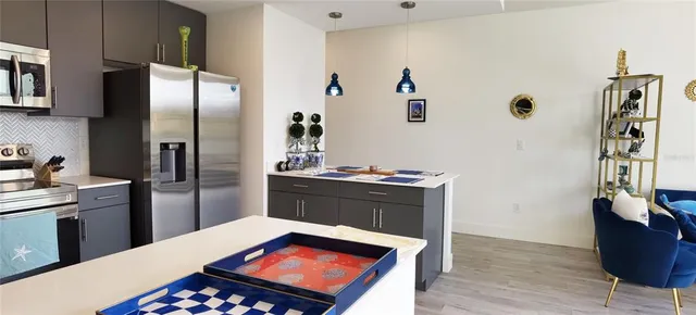 a kitchen with a refrigerator and a stove