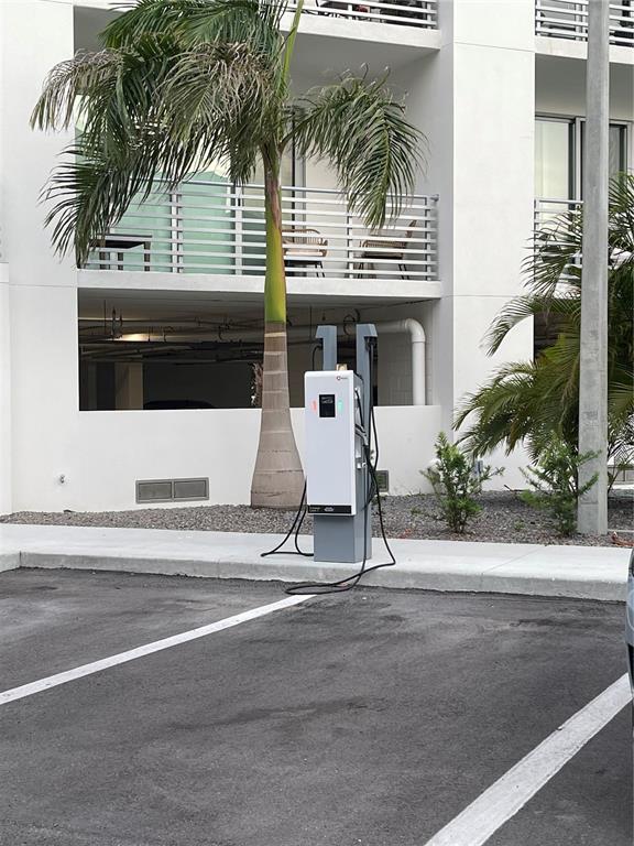 1709 North Tamiami Trail, Unit 213 Sarasota, FL 34234 - Photo 45 of 49 front view of house with a yard and palm trees