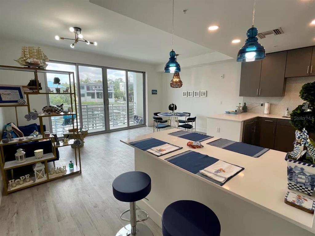 1709 North Tamiami Trail, Unit 213 Sarasota, FL 34234 - Photo 7 of 49 a room with furniture a flat screen tv and a large window