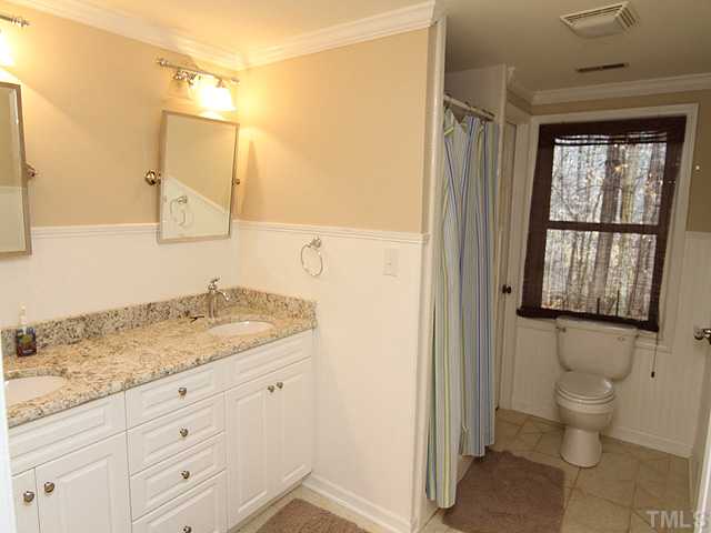 8644 Valley Brook Drive Raleigh, NC 27613 - Photo 13 of 18 LOWER LEVEL FULL BATH: Update with granite counters, undermounted sinks, beadboard and smooth ceilings! The bath opens from both the bedroom and hallway!