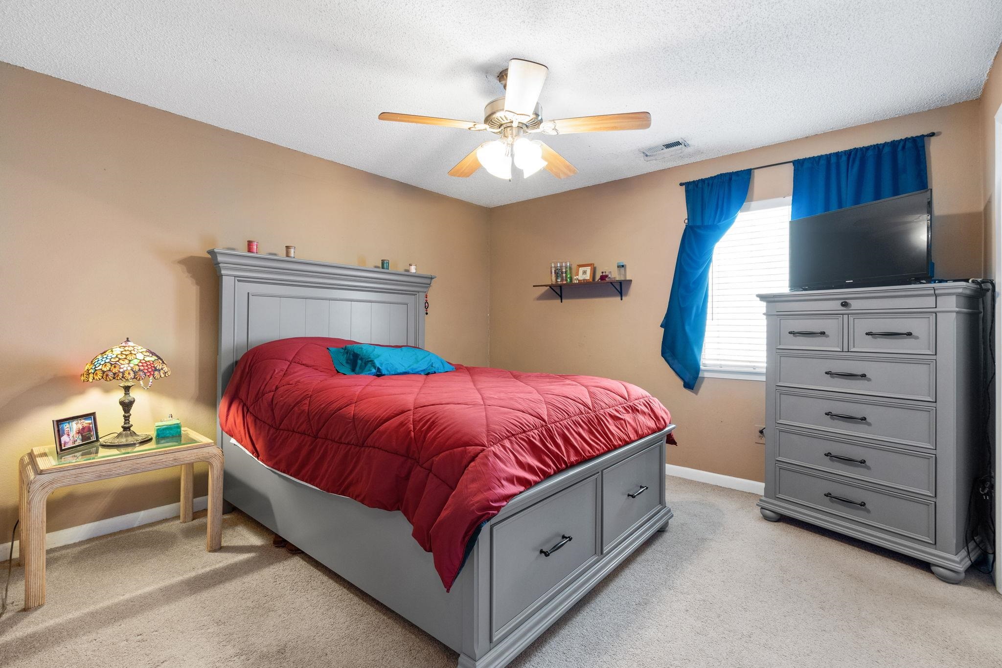 220 Myrtle Greens Drive, Unit I Conway, SC 29526 - Photo 12 of 30 Bedroom with light colored carpet, a ceiling fan, and a textured ceiling