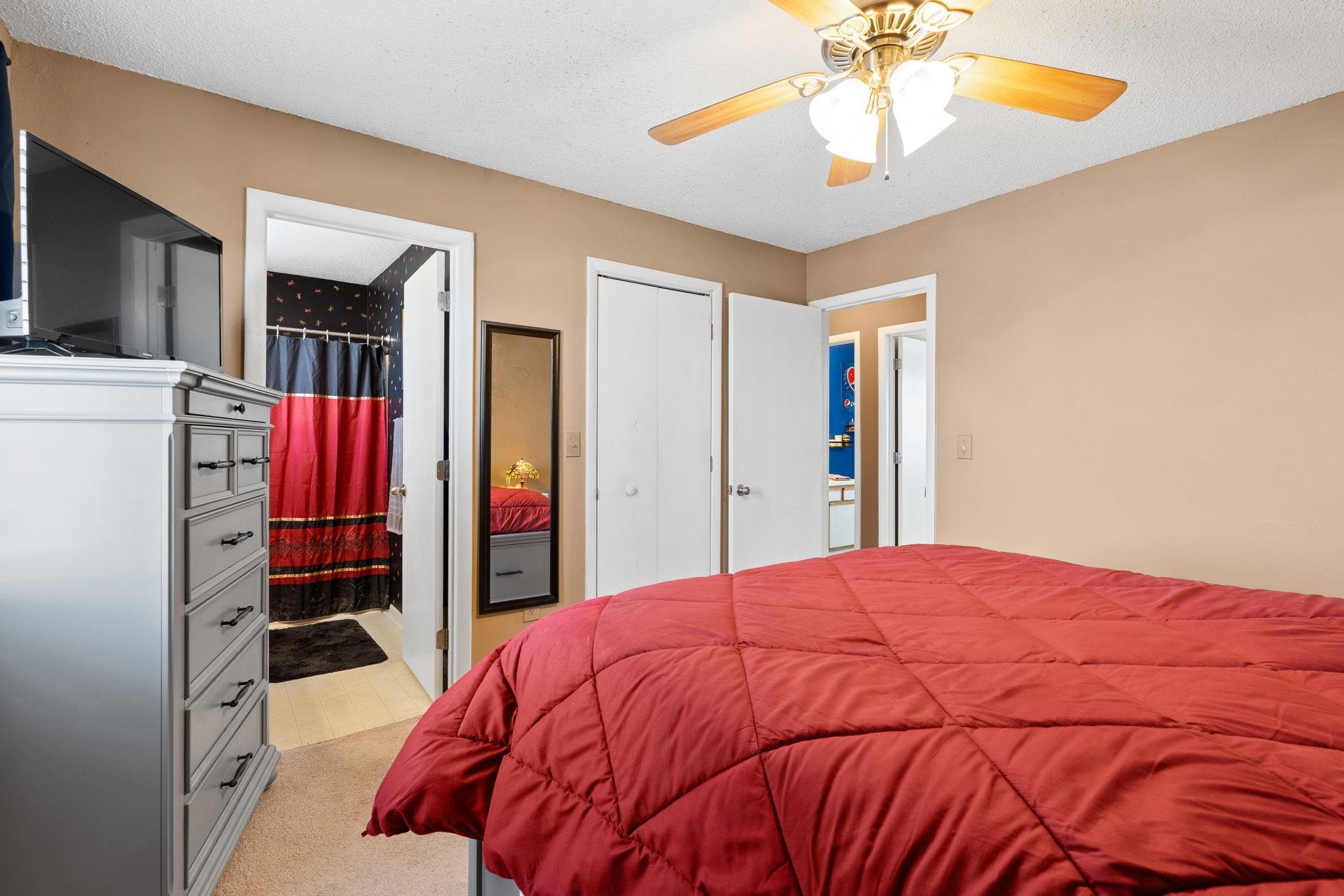 220 Myrtle Greens Drive, Unit I Conway, SC 29526 - Photo 13 of 30 Bedroom featuring ensuite bathroom, light colored carpet, a textured ceiling, and ceiling fan