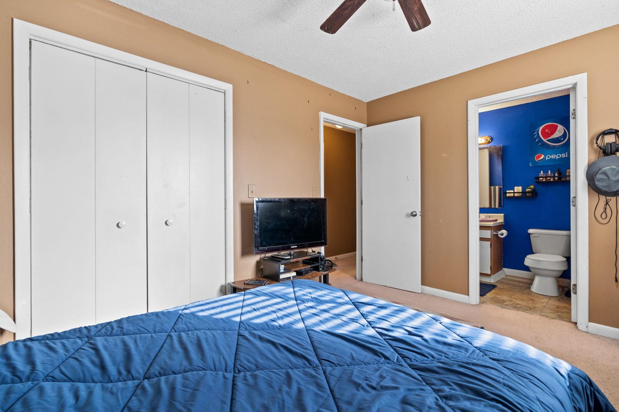 220 Myrtle Greens Drive, Unit I Conway, SC 29526 - Photo 16 of 30 Carpeted bedroom featuring a closet, a textured ceiling, a ceiling fan, and ensuite bath