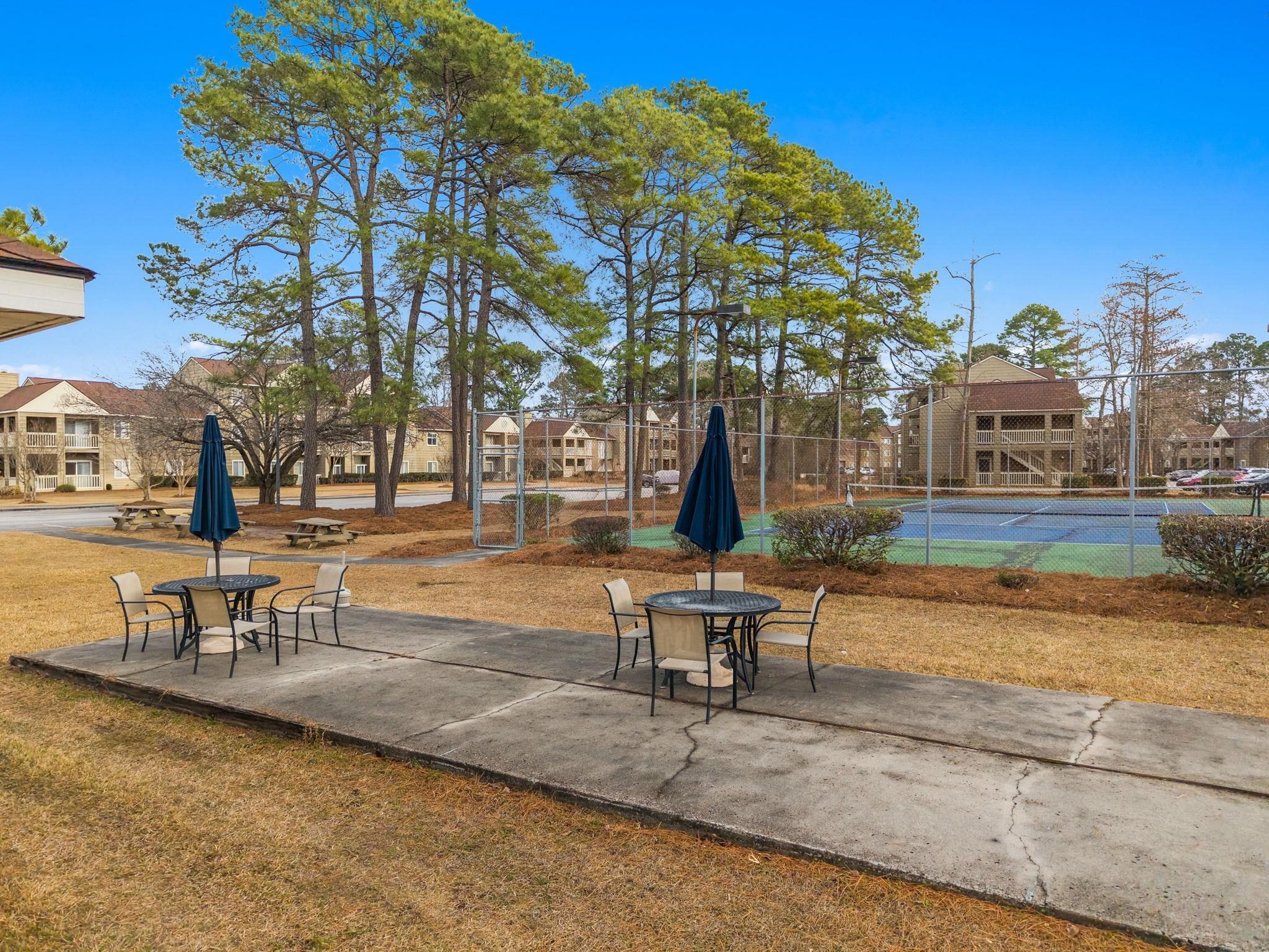 220 Myrtle Greens Drive, Unit I Conway, SC 29526 - Photo 21 of 30 View of property's community featuring a residential view, a tennis court, a patio, and outdoor dining area