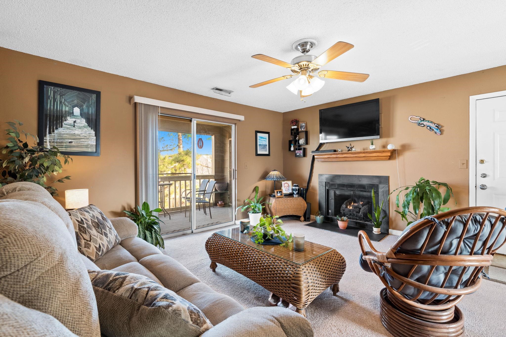 220 Myrtle Greens Drive, Unit I Conway, SC 29526 - Photo 4 of 30 Living room featuring a fireplace with flush hearth, ceiling fan, and carpet flooring